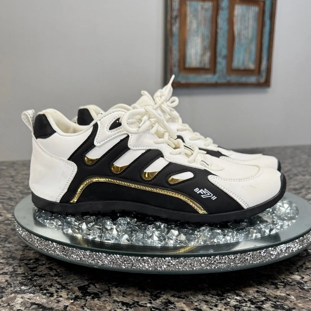 White and Black womens fashion Sneakers with gold accents EUC 10